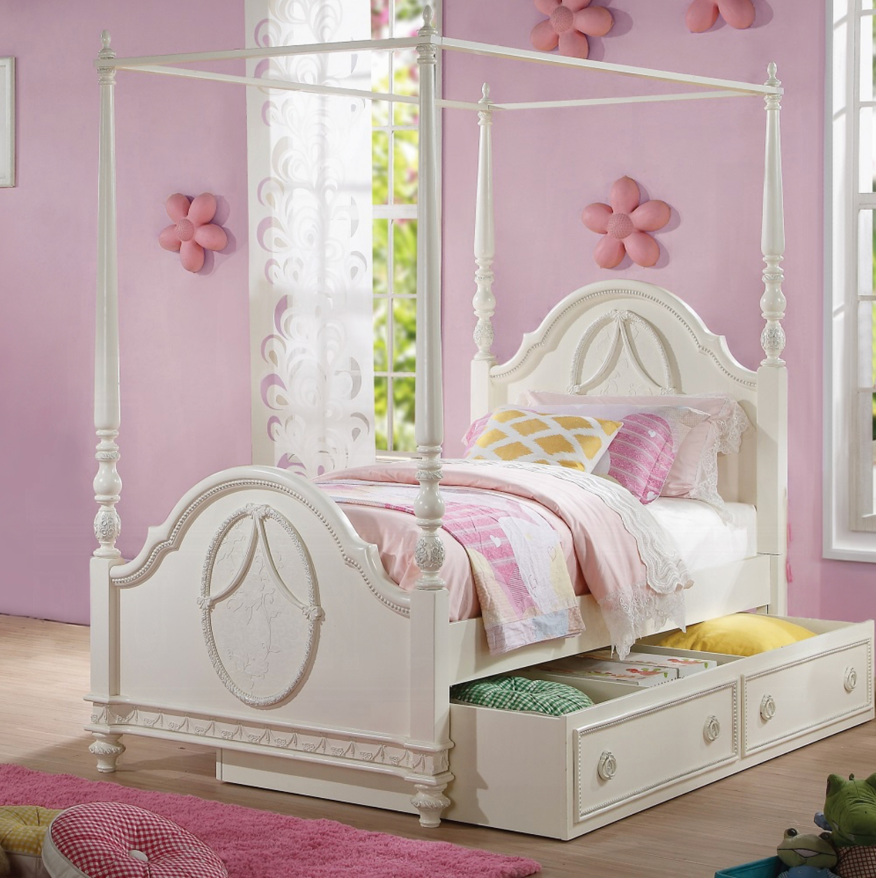 A white canopy bed with drawers underneath it