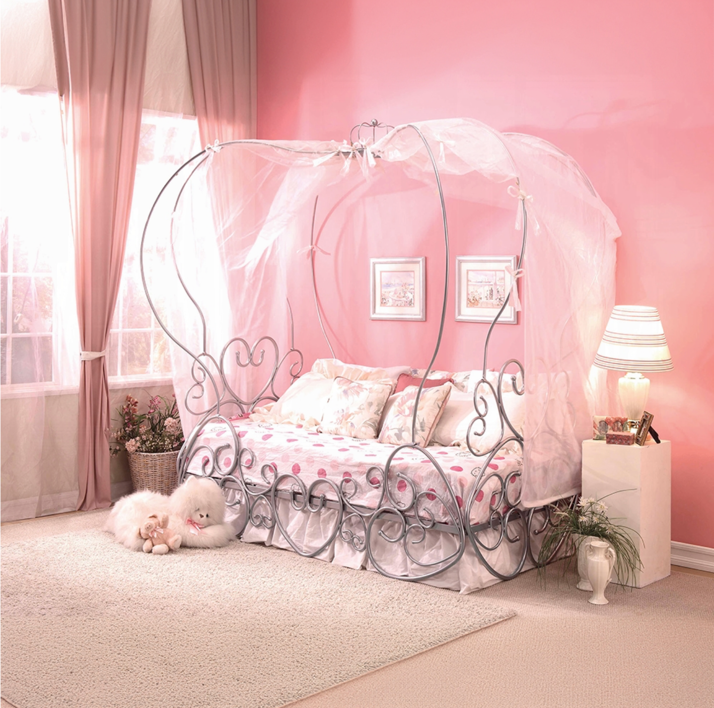 A bedroom with pink walls and a canopy bed