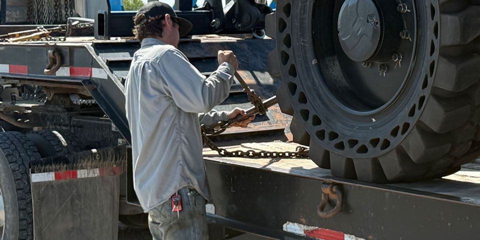 Construction vehicle repair technician working on-site