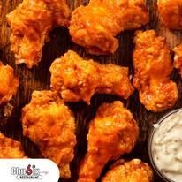 Buffalo wings with dipping sauce.