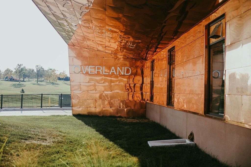 Exterior of a building with weathered copper siding and