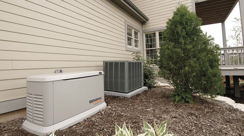 A generator is sitting outside of a house next to an air conditioner