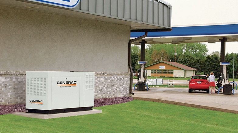 A generator is sitting outside of a gas station