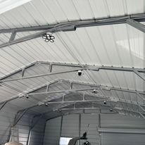 The inside of a garage with a roof and a ceiling.