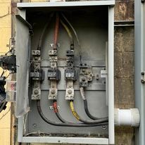 A close up of an electrical box on a wall.