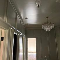 A hallway with a chandelier hanging from the ceiling.