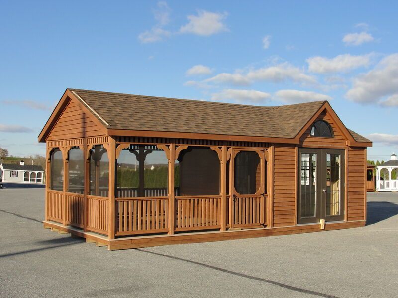 A small wooden house with a screened in porch