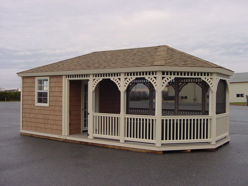 A small house with a screened in porch on the side