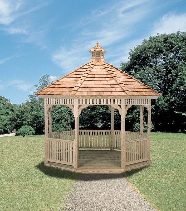 A wooden gazebo is sitting in the middle of a grassy field