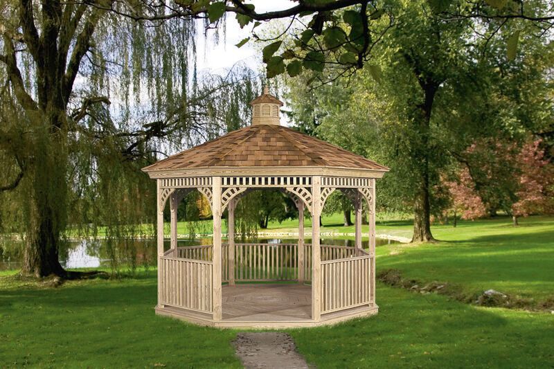 A wooden gazebo is sitting in the middle of a lush green park.