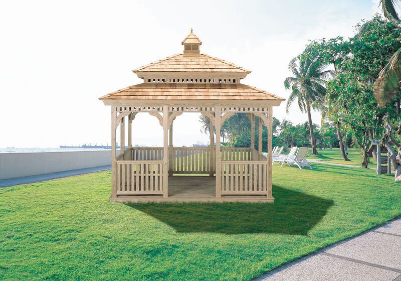 A gazebo is sitting in the middle of a lush green field