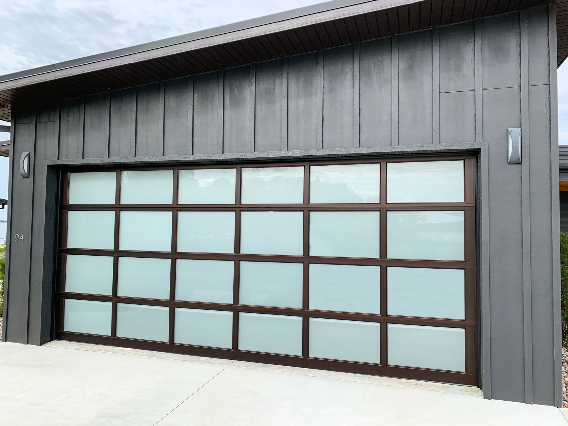 A large garage door with a lot of windows on a house.