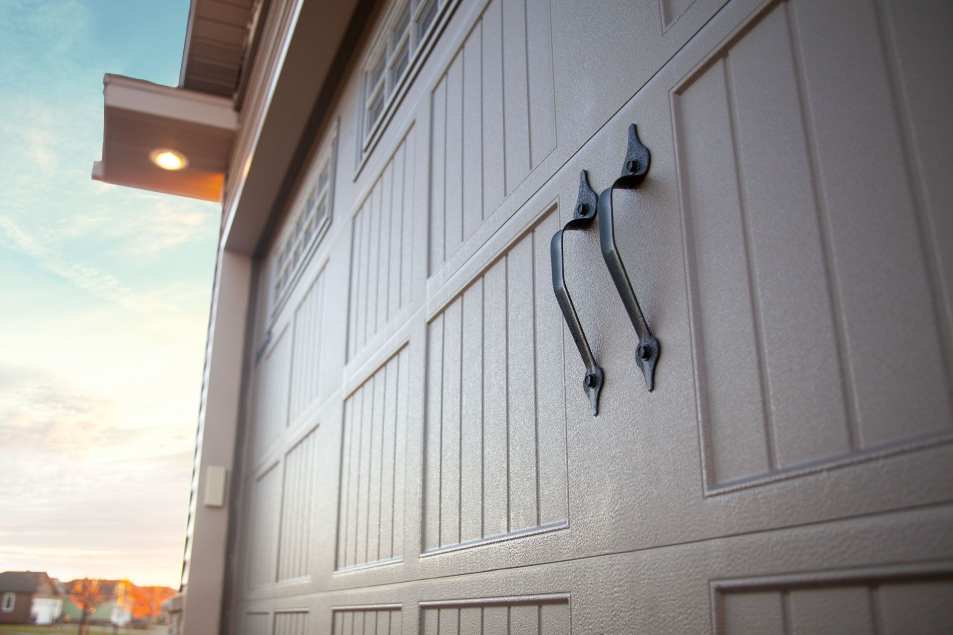 A close up of a garage door with two handles on it.