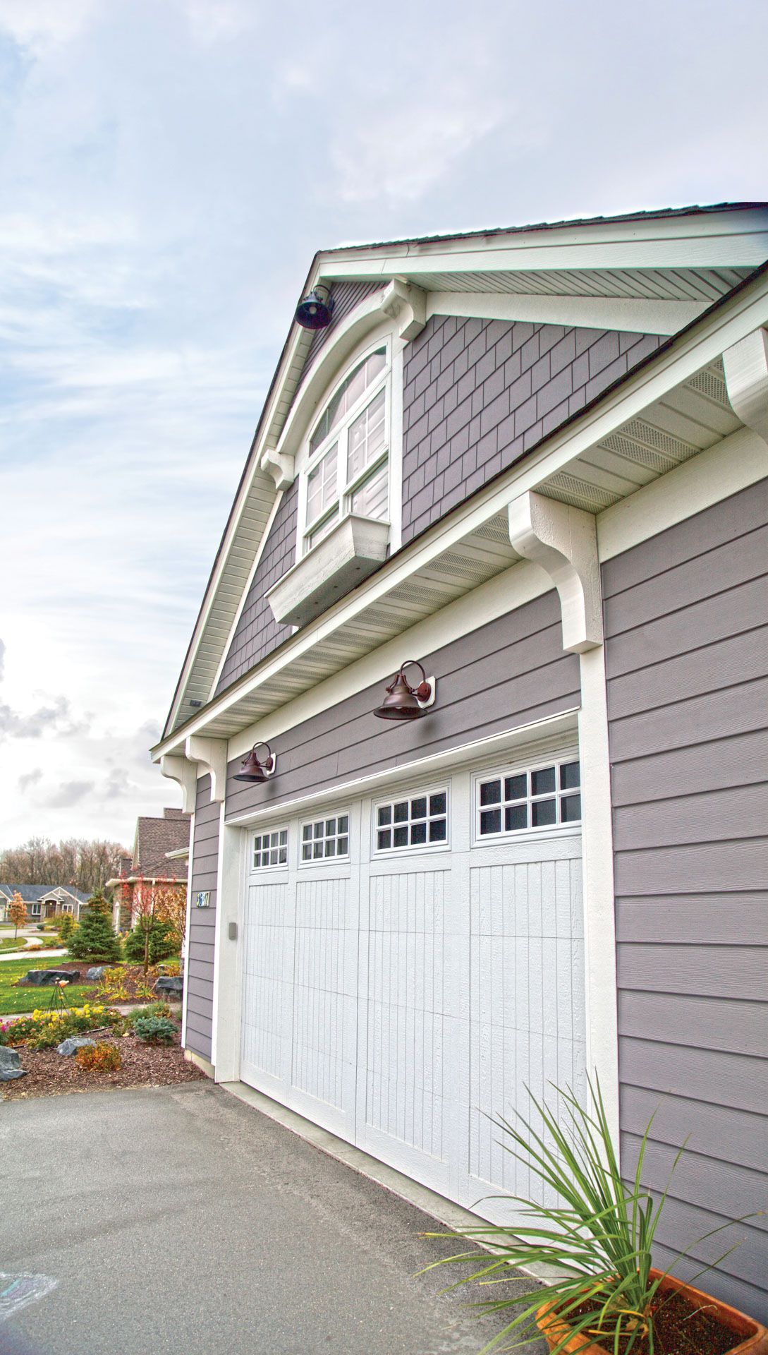 A gray and white garage with a white door and a window.