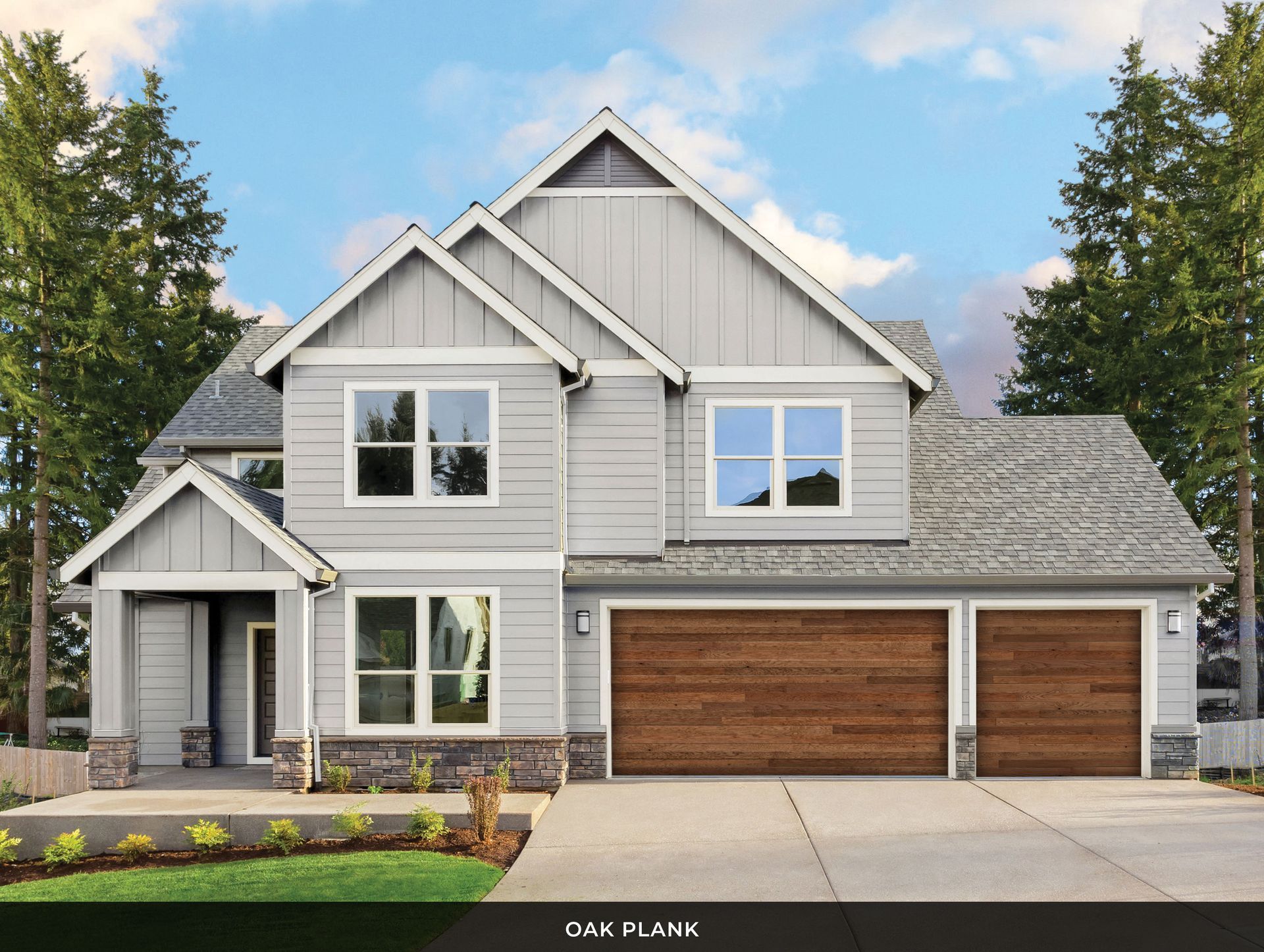 A large gray house with a wooden garage door