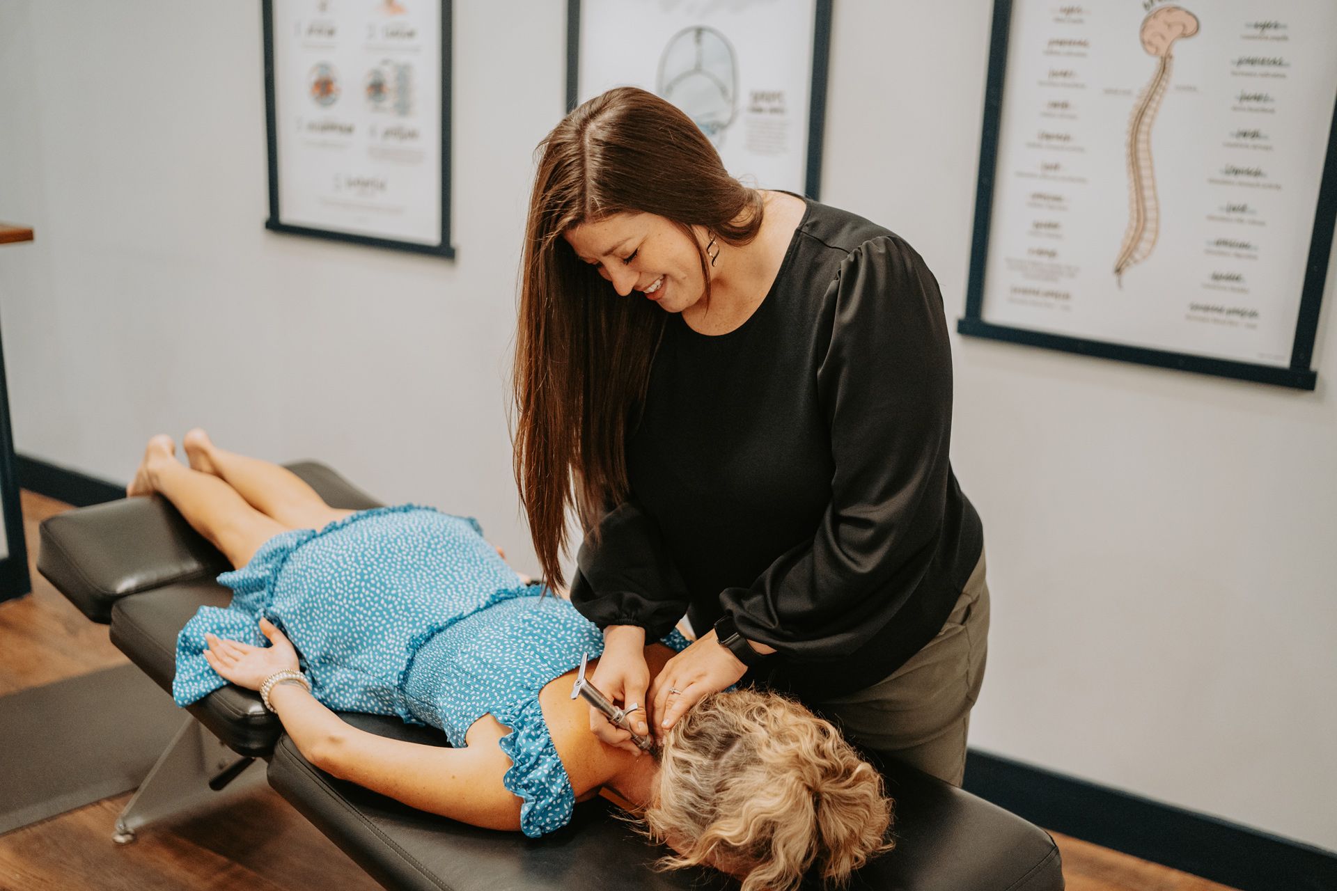 A woman is giving a woman a massage on a table.