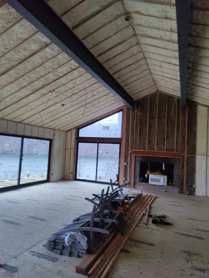 A large room with a vaulted ceiling and a fireplace.