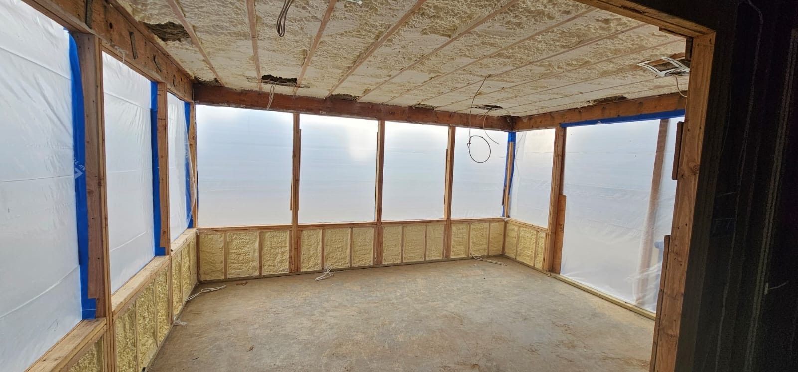 A room with a lot of windows and foam on the ceiling.