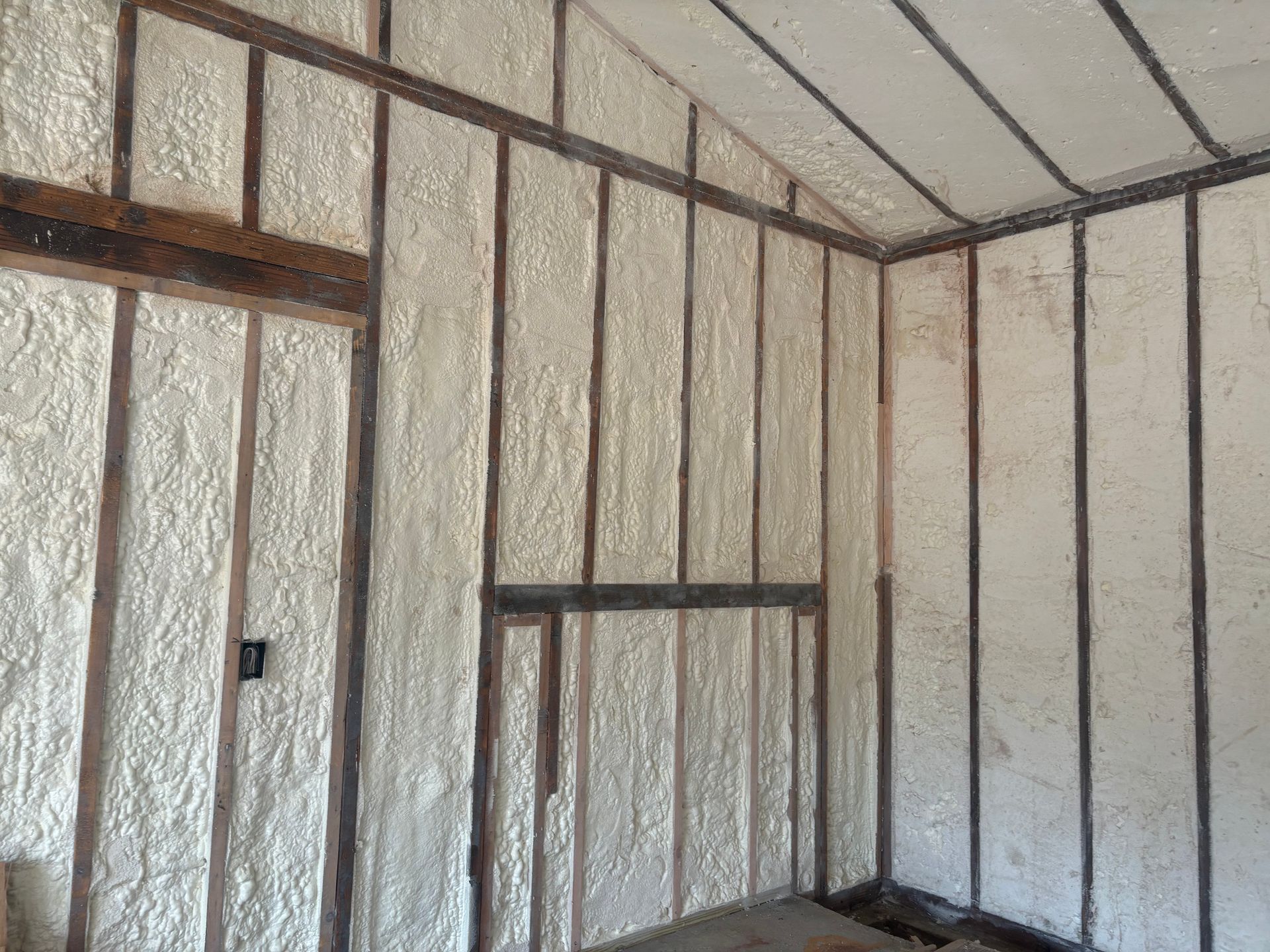 A room with foam insulation on the walls and ceiling.