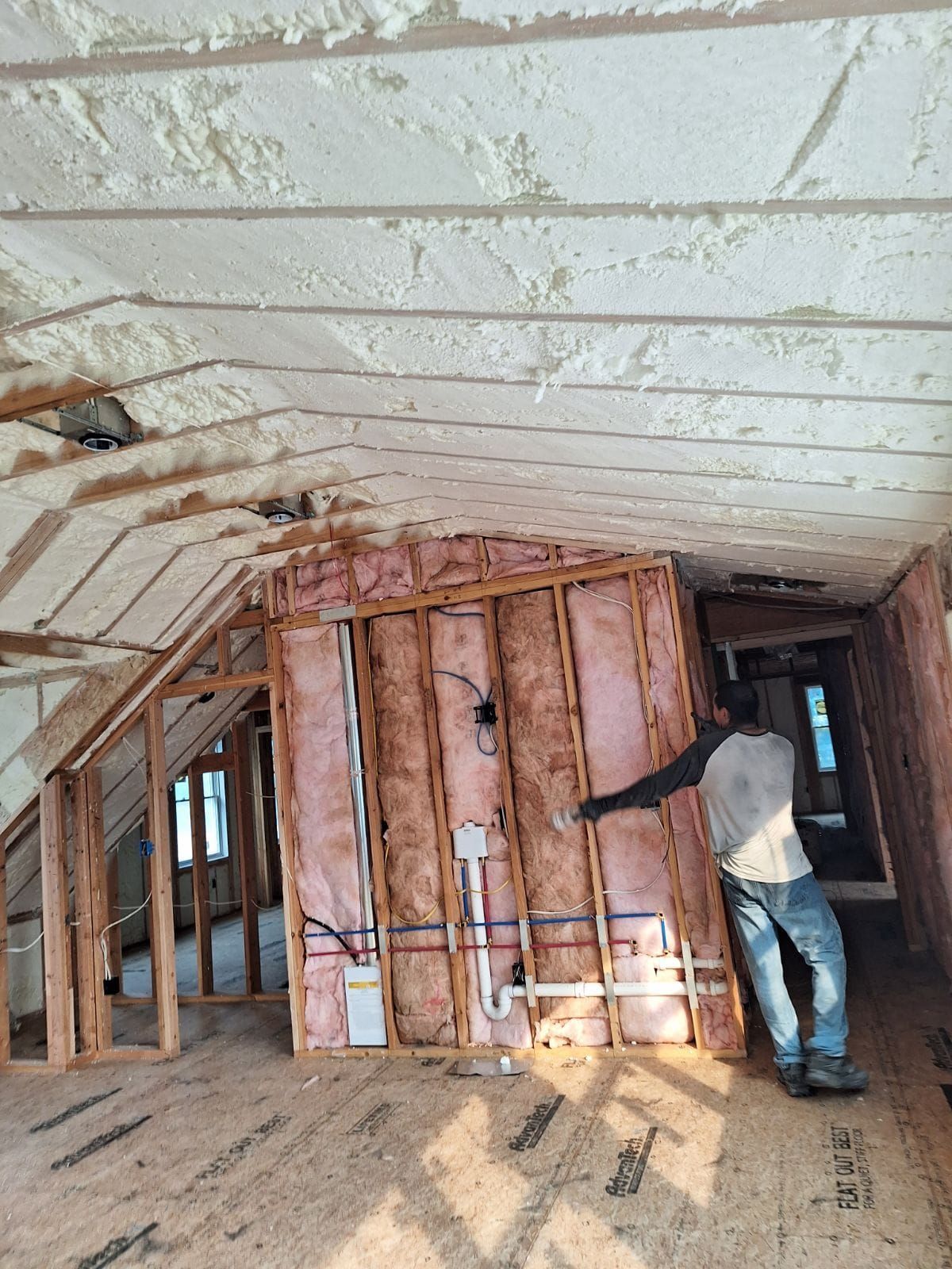 A man is standing in a room with foam on the ceiling.