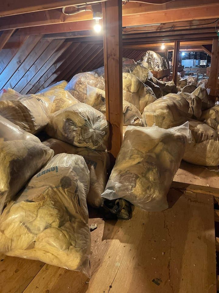 There are many bags of insulation in the attic.