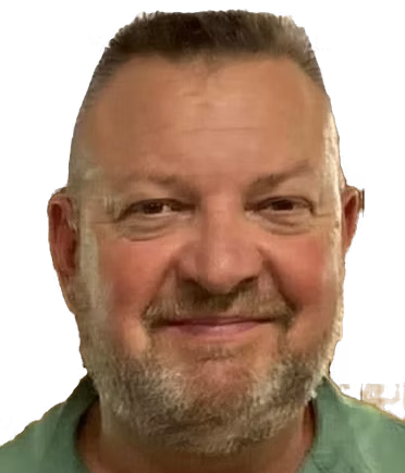 Smiling man with short gray hair and beard against a white background