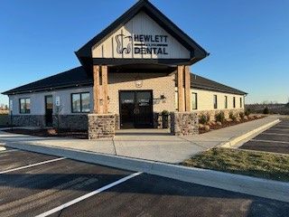 A dental office with a parking lot in front of it