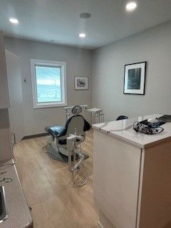 A dental office with a dental chair and a window