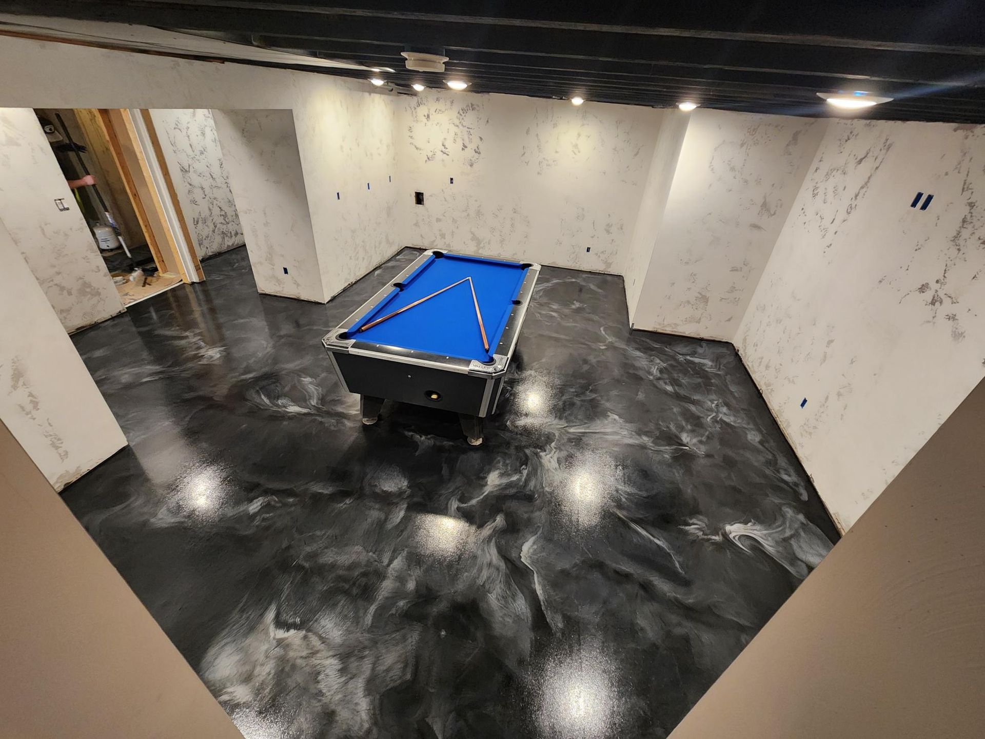 A pool table is sitting in the middle of a room.