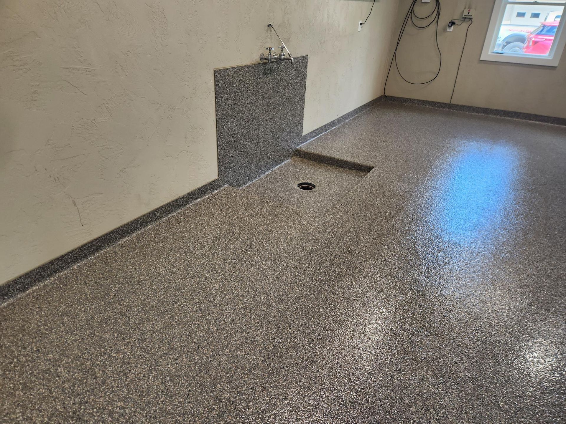 A room with a concrete floor and a window.