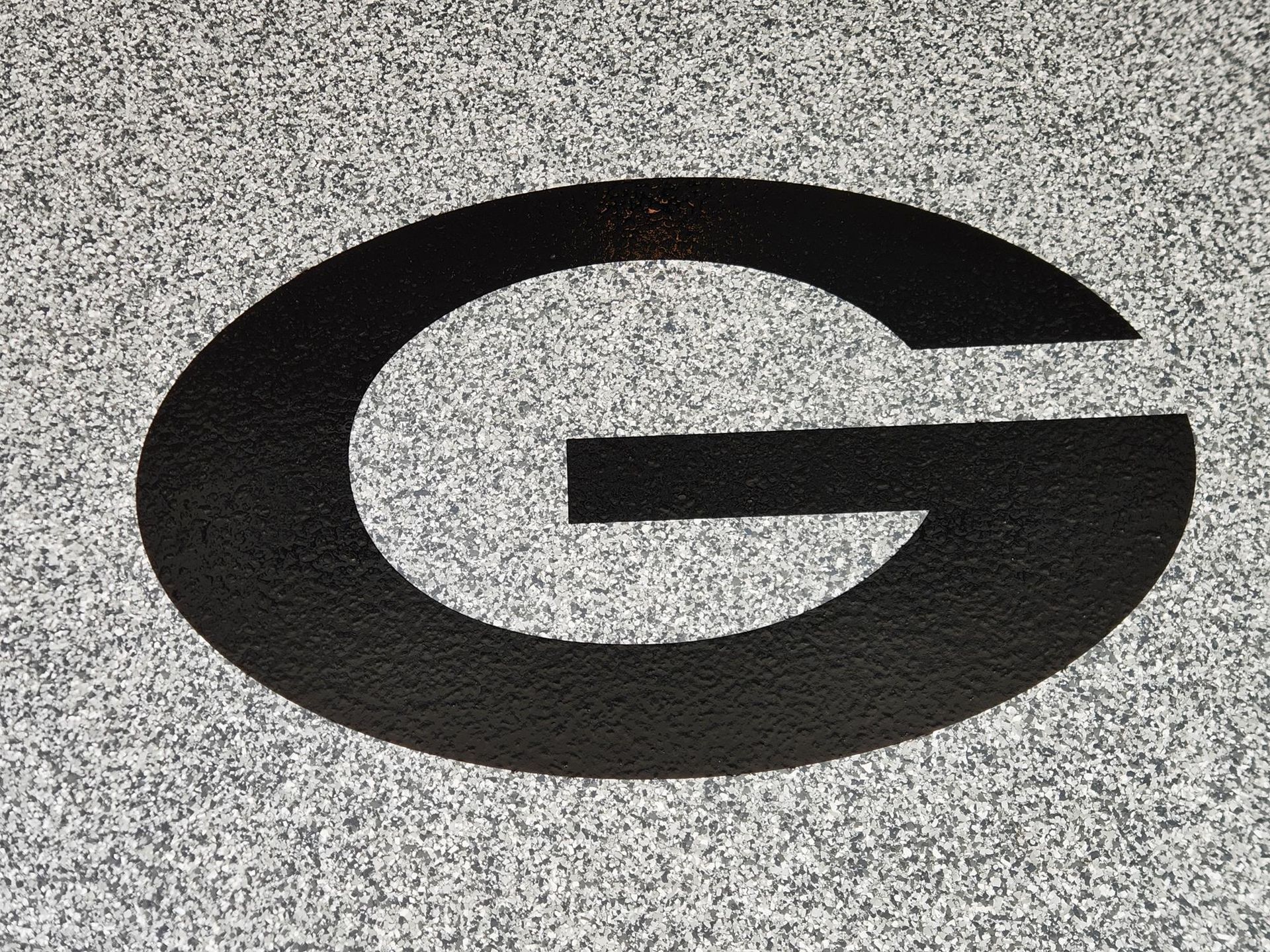 A black letter g on a gray background