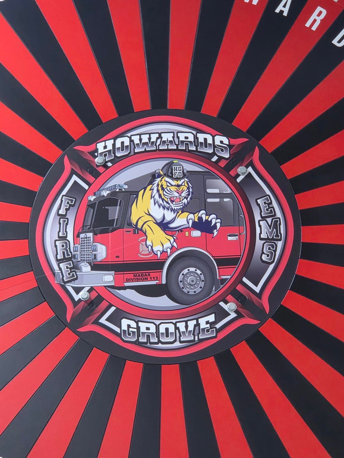Red and black radial design with a central circular logo featuring a bulldog and a red truck