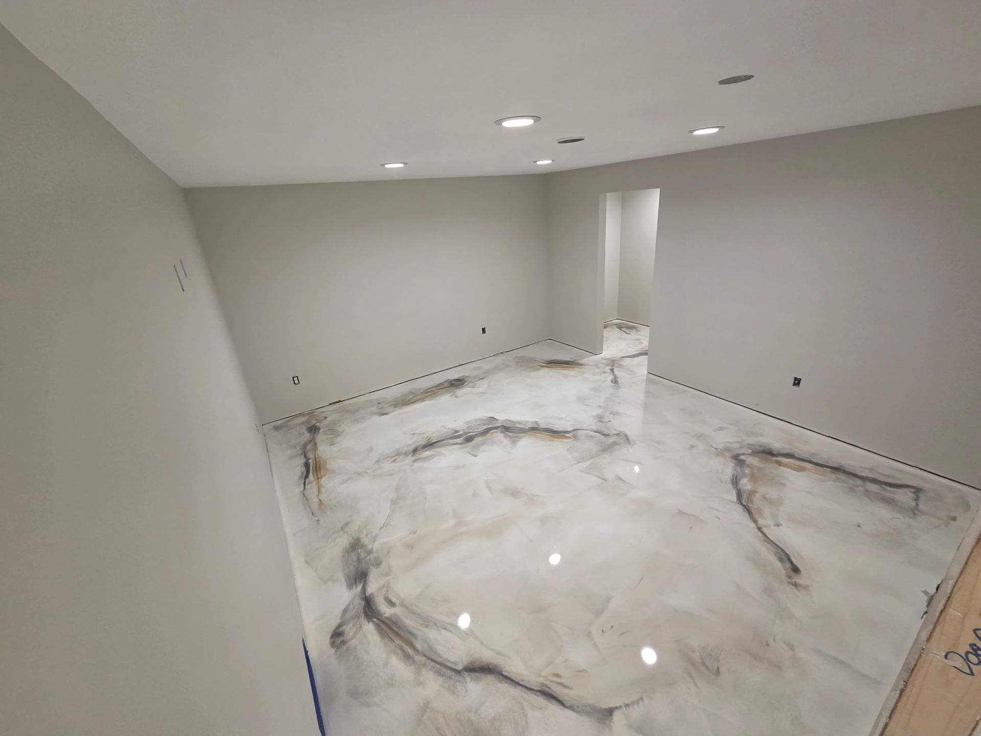 Empty modern room with gray walls and glossy white marble floor, lit by recessed ceiling lights