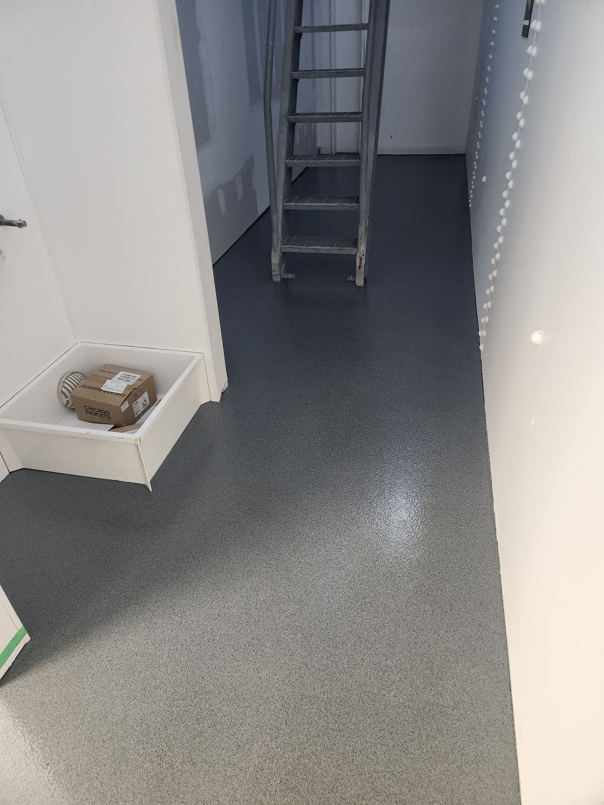 A ladder is sitting on the floor of a room.