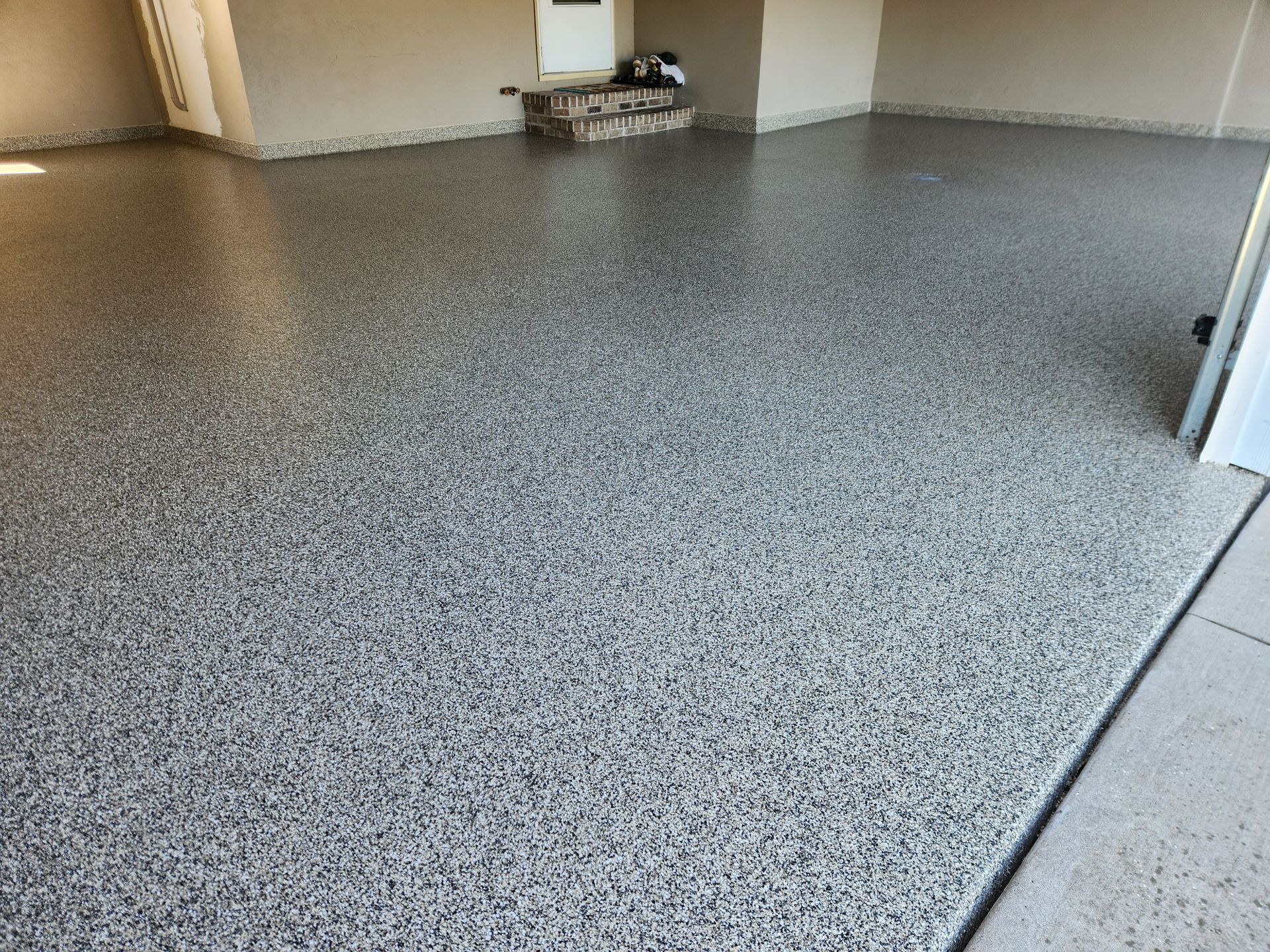 A garage floor with a lot of small stones on it.