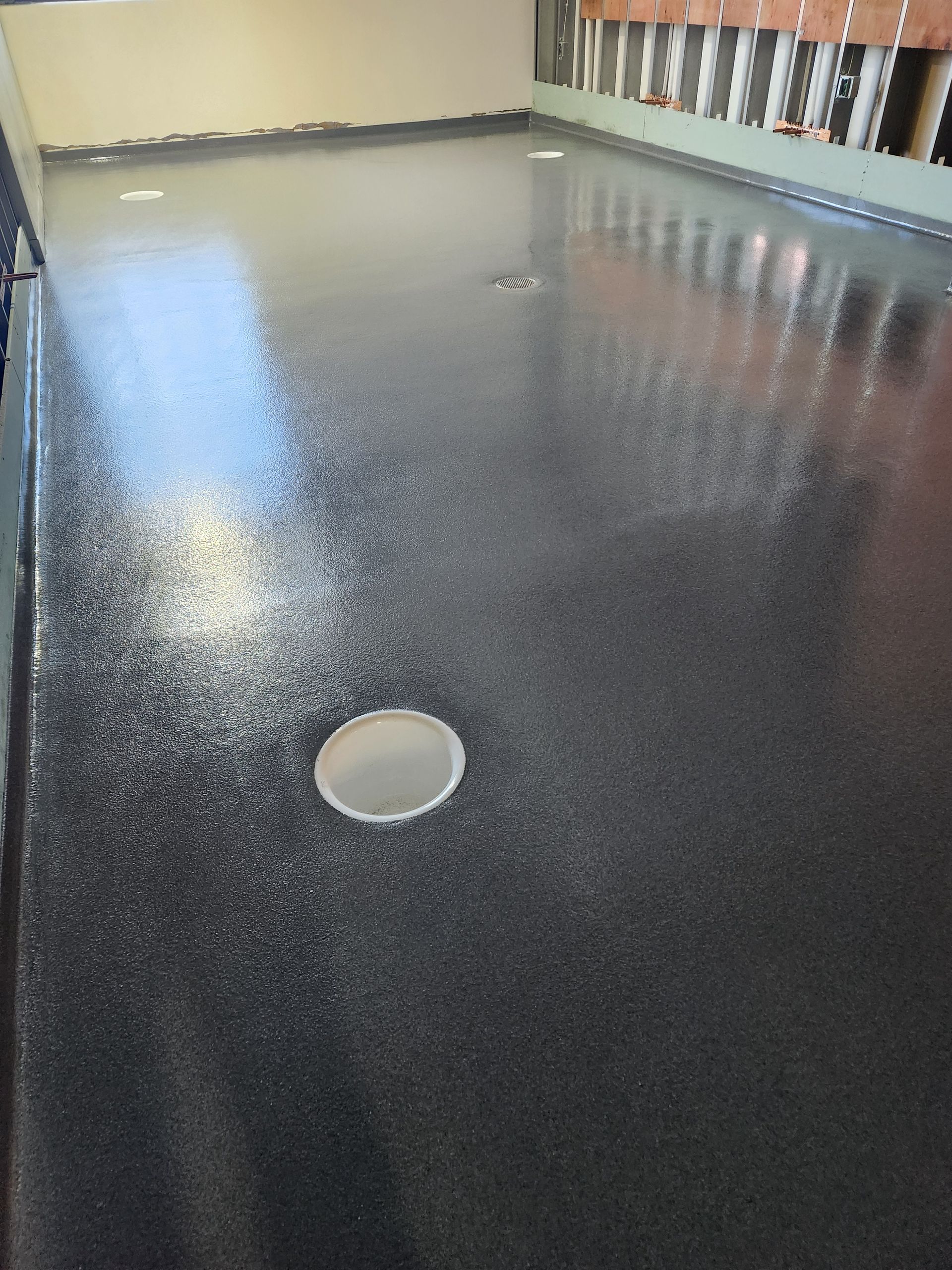 A black floor with a hole in the middle of it