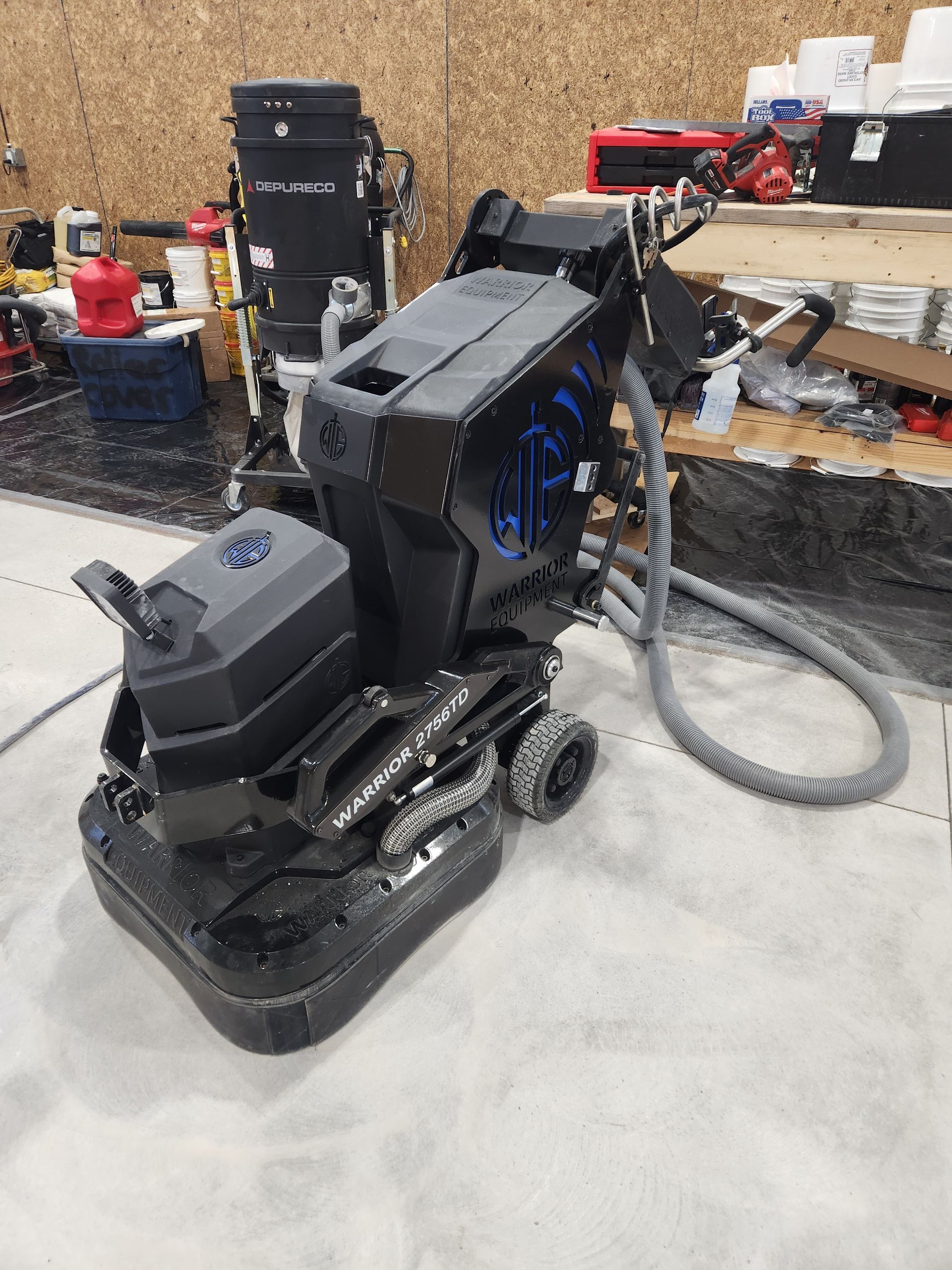 A machine is sitting on a concrete floor in a garage.