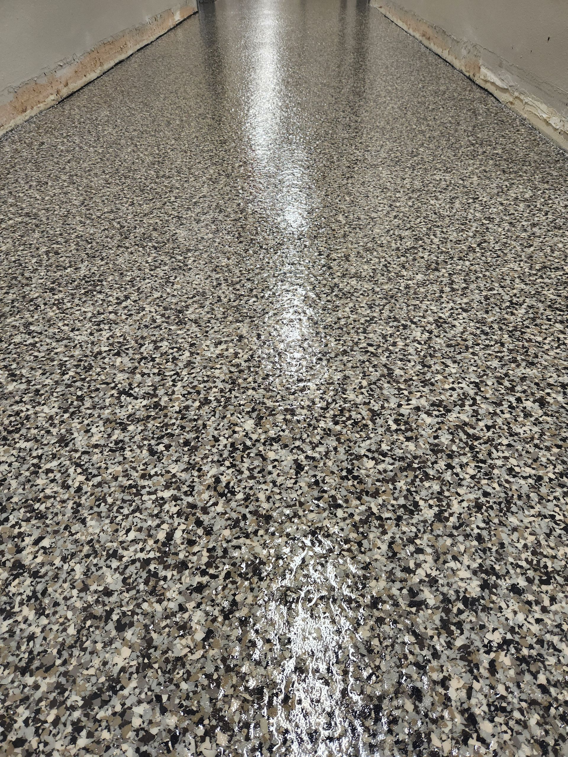 A close up of a shiny concrete floor in a garage.