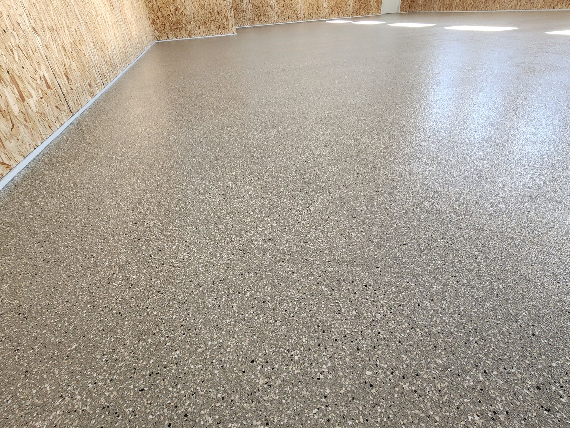 A garage floor with a lot of small stones on it.