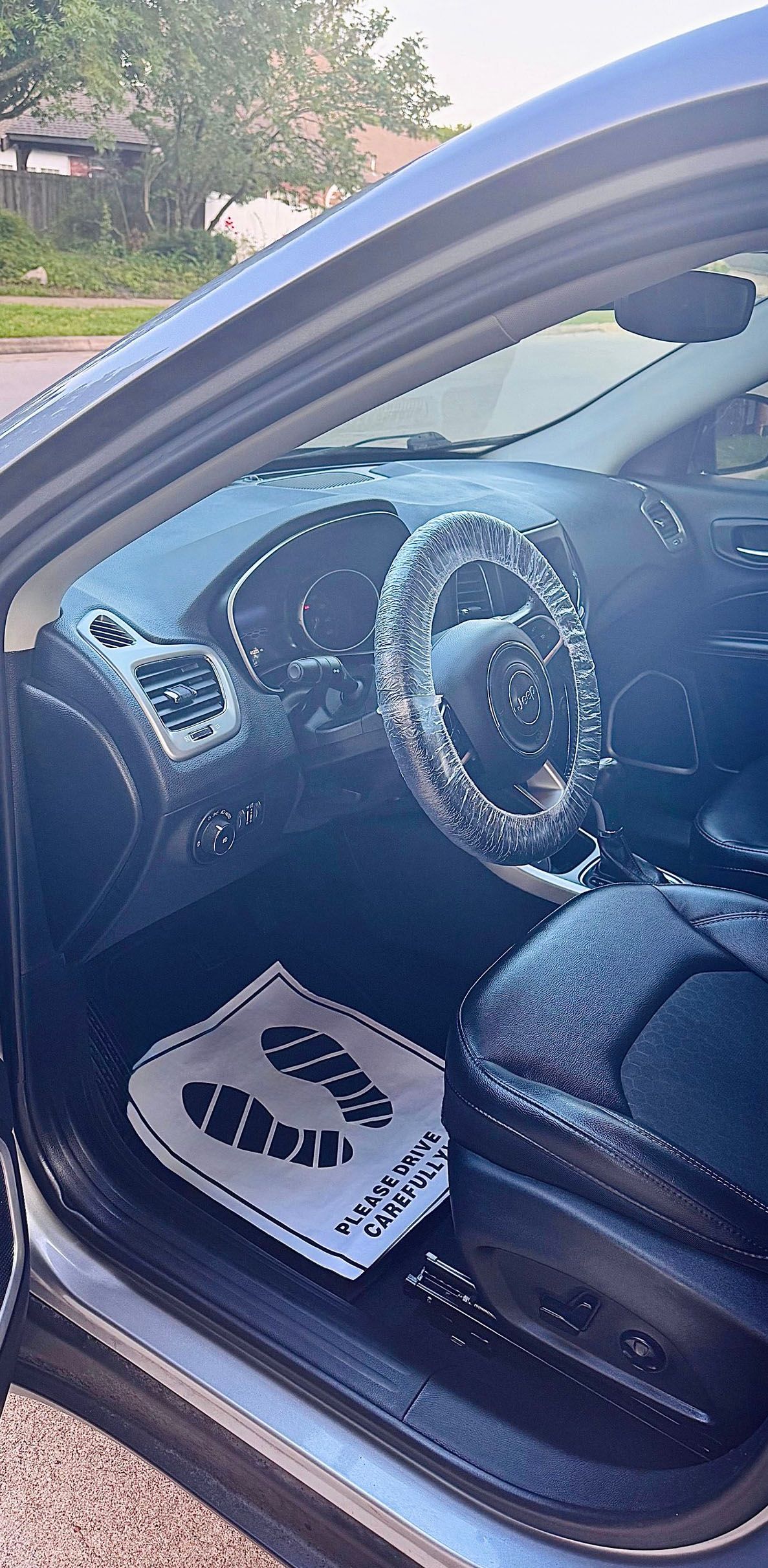 Interior of a car with a protective steering wheel cover and a 