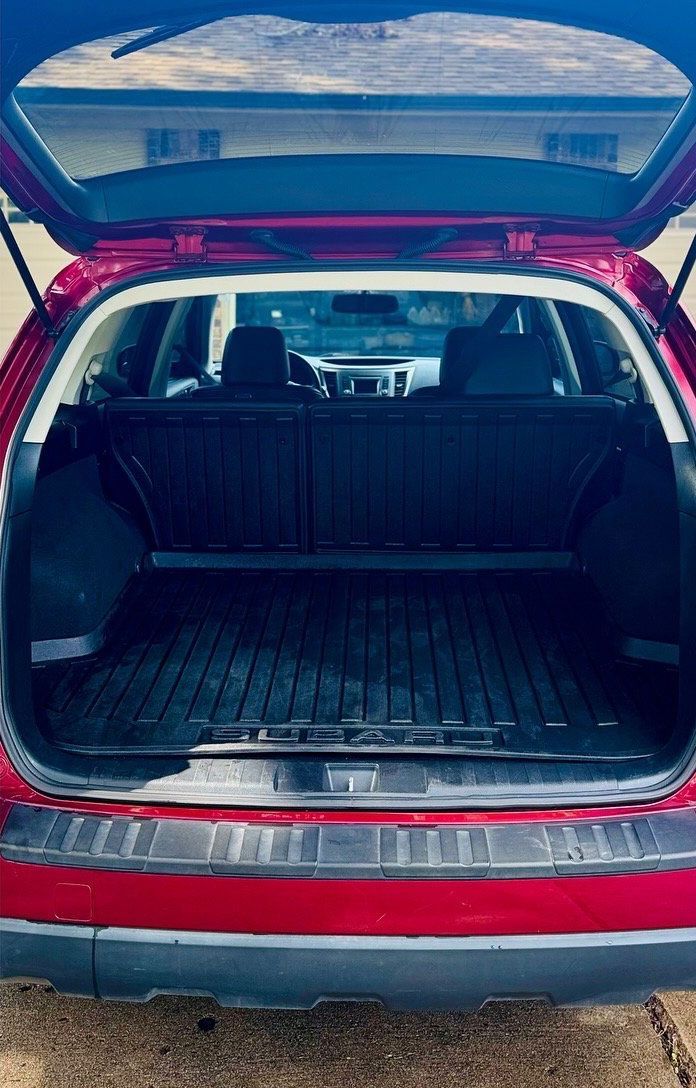 Red car trunk open, revealing cargo area.