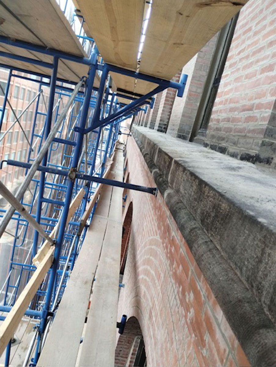 A brick building with scaffolding on the side of it