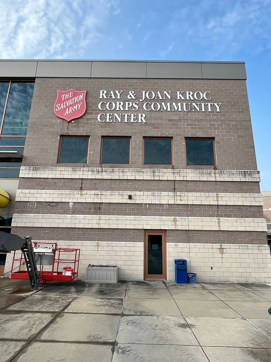 A large brick building with a sign that says Ray & Joan Kroc Corps Community Center