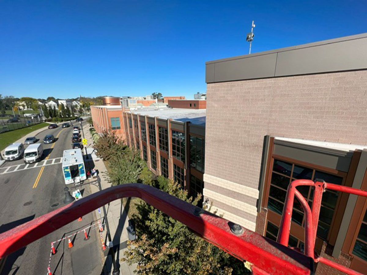 An aerial view of a building with a red ladder in front of it