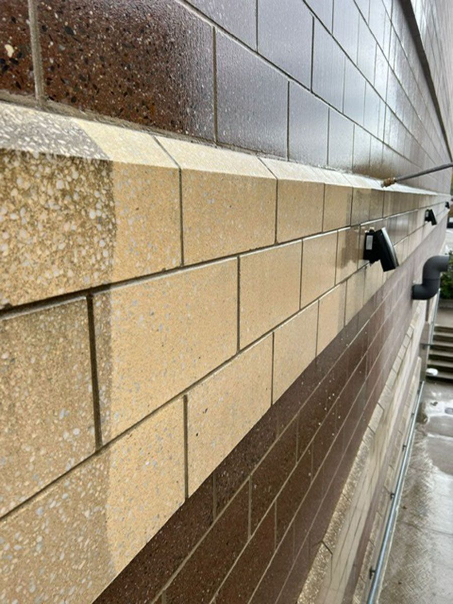 A close-up of a brick wall with a staircase in the background