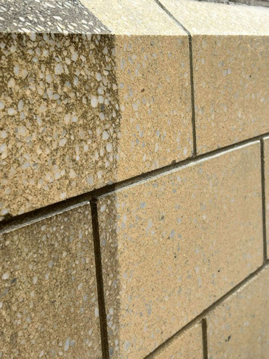 A close-up of a brick wall with a stain on it