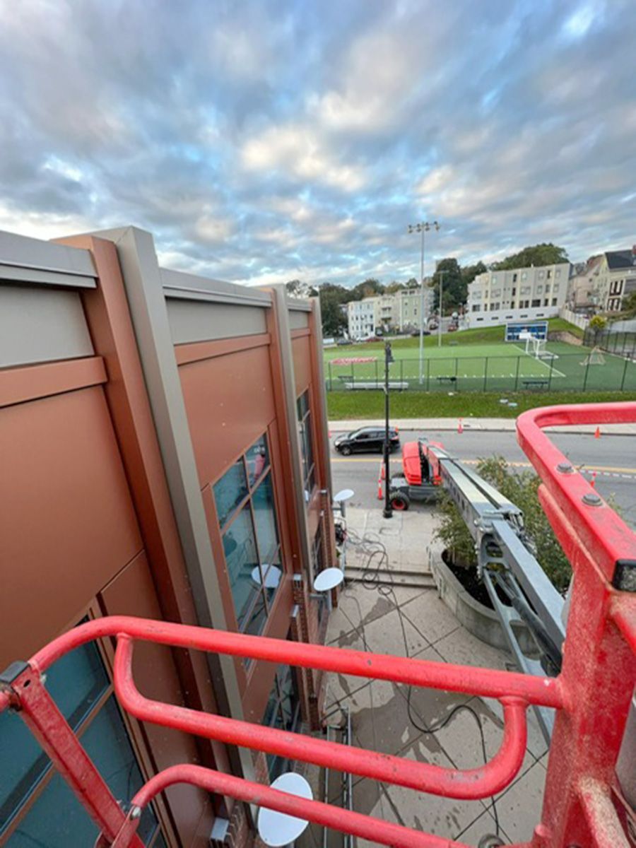 A red crane is sitting on top of a building