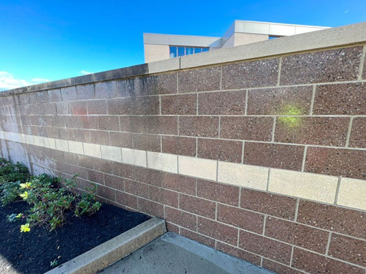 A brick wall with a white stripe on the side of it
