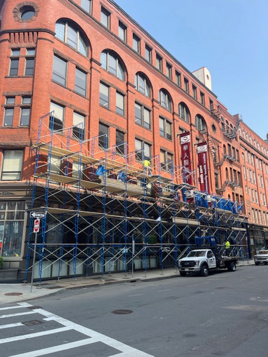 A large brick building with scaffolding in front of it