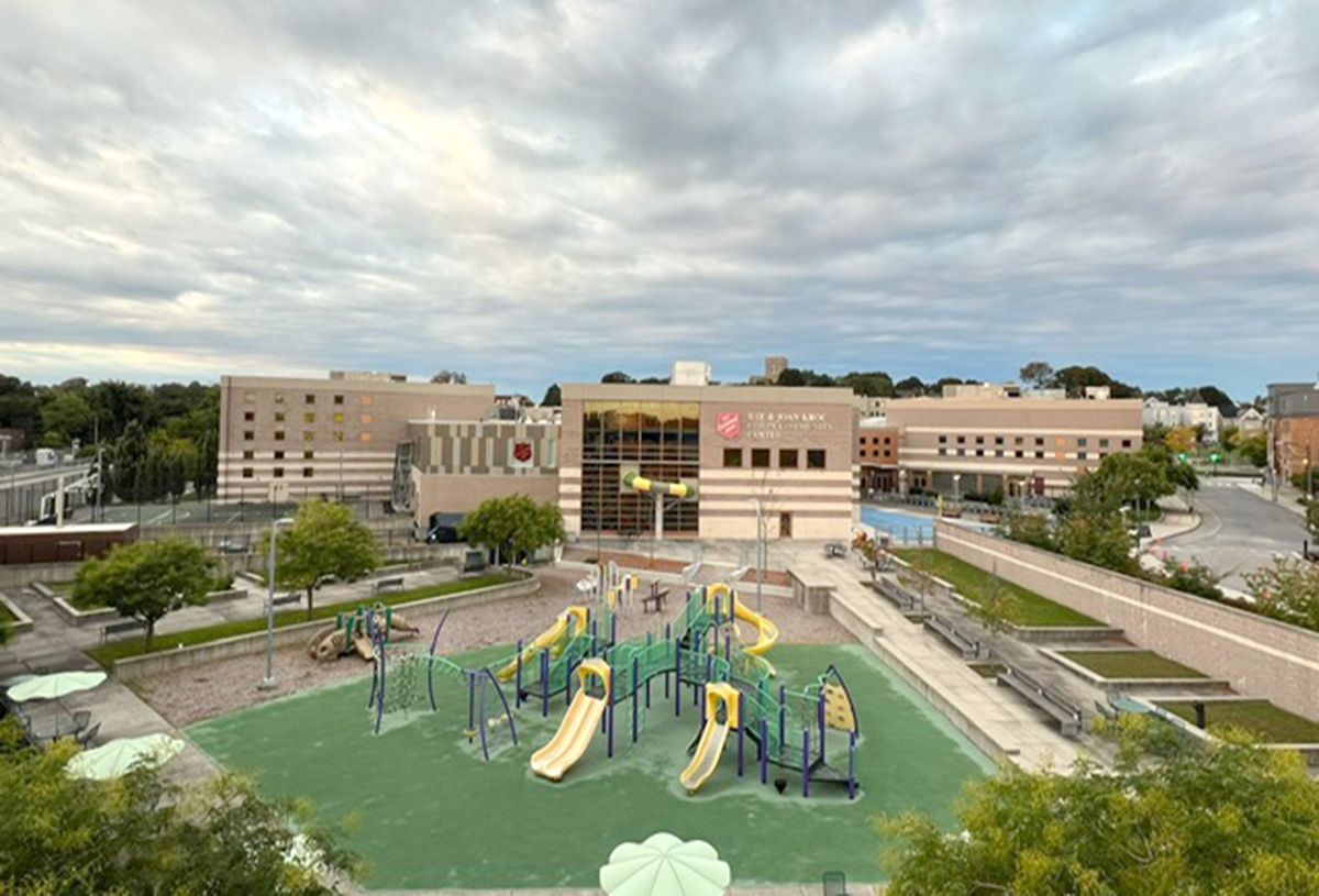 An aerial view of a playground in front of a building